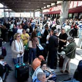 People wait outside the Atocha train station in Madrid after its closure as a massive power outage hits Spain. Picture: Thomas Coex/AFP via Getty Images