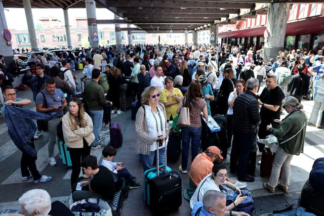 People wait outside the Atocha train station in Madrid after its closure as a massive power outage hits Spain. Picture: Thomas Coex/AFP via Getty Images