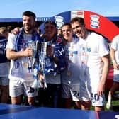 Birmingham City's Grant Hanley, goalkeeper Bradley Mayo, Luke Harris and Kieran Dowell with the Sky Bet League One trophy. Cr: PA.