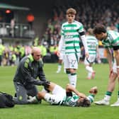 Celtic winger Jota receives treatment on a knee problem before leaving the field in the 5-0 win over Dundee United.