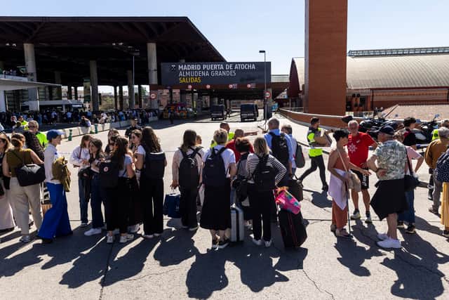 People stand behind a police cordon outside Madrid Puerta de Atocha - Almudena Grandes train station in Madrid, Spain. Picture: Pablo Blazquez Dominguez/Getty Images