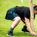 A female competitor takes part in the caber toss at the Glenurquhart Highlands Games in 2024