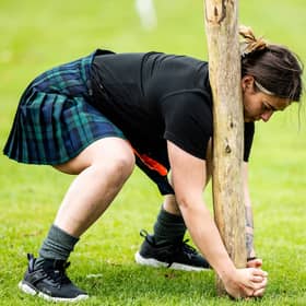 A female competitor takes part in the caber toss at the Glenurquhart Highlands Games in 2024