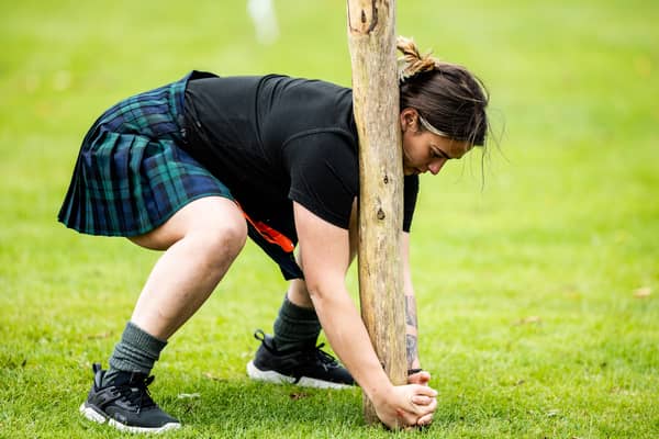 A female competitor takes part in the caber toss at the Glenurquhart Highlands Games in 2024