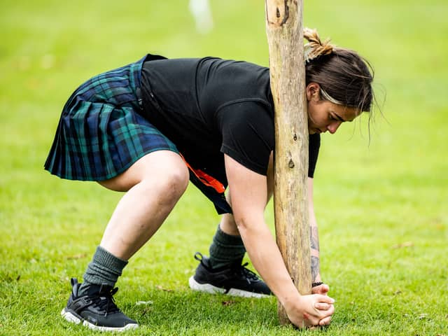 A female competitor takes part in the caber toss at the Glenurquhart Highlands Games in 2024