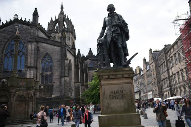 The statue of Adam Smith on Edinburgh's Royal Mile, has his name on the front and the names of the people who funded the statue on the back (Picture: Oli Scarff)
