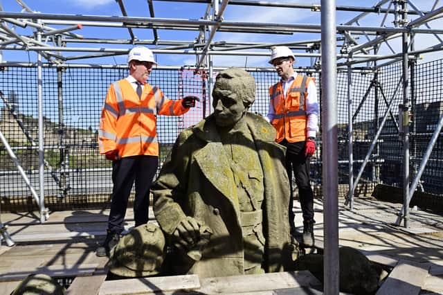 City council transport convener Stephen Jenkinson and Balfour Beatty project manager Rory McFadden with a memorial to the King's Own Scottish Borderers being refurbished on the bridge