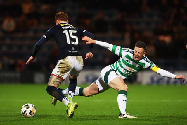 Celtic's Callum McGregor challenges Dundee's Simon Murray during the match at Dens Park on January 14, 2025. (Photo by Craig Williamson / SNS Group)