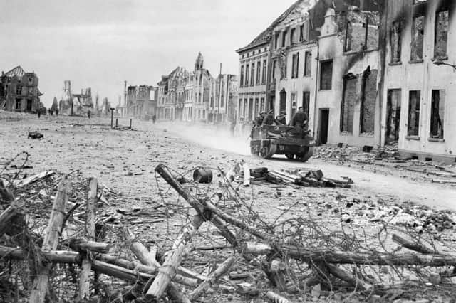 British reinforcements move up in the advance east of the Rhine on March 27, 1945 through the shattered town of Rees, Germany, which fell to the Gordon Highlanders after fierce house-to-house fighting, during the last stages of World War II.