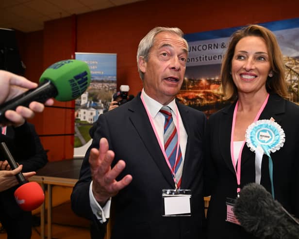 RUNCORN, ENGLAND - MAY 02: Nigel Farage (L) and Sarah Pochin of the Reform Party speak to members of the media as a vote recount is conducted during the Runcorn and Helsby by-election at the DCBL Stadium on May 2, 2025 in Runcorn, England. The Runcorn and Helsby seat is in contention after MP Mike Amesbury was prosecuted for a drunken assault on a constituent. Once one of Labour's safest seats with a 14696-vote majority, Nigel Farage's Reform Party is polling well. (Photo by Anthony Devlin/Getty Images)