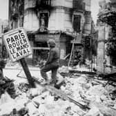 Infantry soliders search the wrecked streets of Caen for snipers in 1944, with the Kings Own's Scottish Borderers dispatched to the town. PIC: Photo by Keystone/Getty Images)