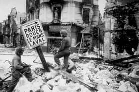 Infantry soliders search the wrecked streets of Caen for snipers in 1944, with the Kings Own's Scottish Borderers dispatched to the town. PIC: Photo by Keystone/Getty Images)