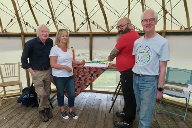 John Hart (far left) and other members of the community buyout following news of their successful purchase 