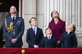 Prince William, Prince of Wales, Prince George of Wales, Prince Louis of Wales, Catherine, Princess of Wales and Princess Charlotte of Wales watch the Red Arrows flypast from Buckingham Palace.