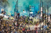 Leeds United fans line the streets to celebrate the club's promotion back to the Premier League.