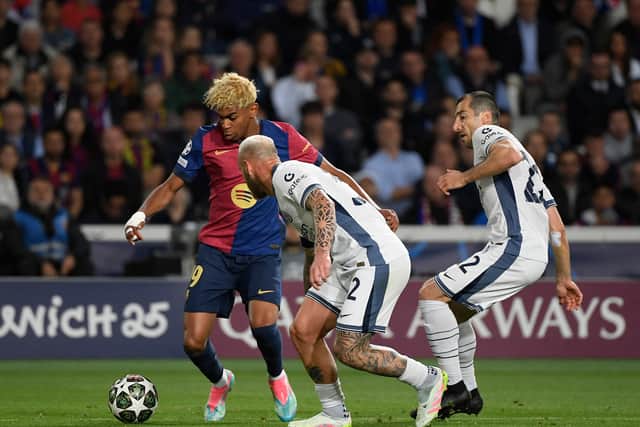 Barcelona's Lamine Yamal fights for the ball with Inter Mila duo Federico Dimarco and Hakan Calhanoglu during last week's Champions League semi-final first leg at Estadi Olimpic Lluis Companys in Montjuic. (Photo by JOSEP LAGO/AFP via Getty Images)          