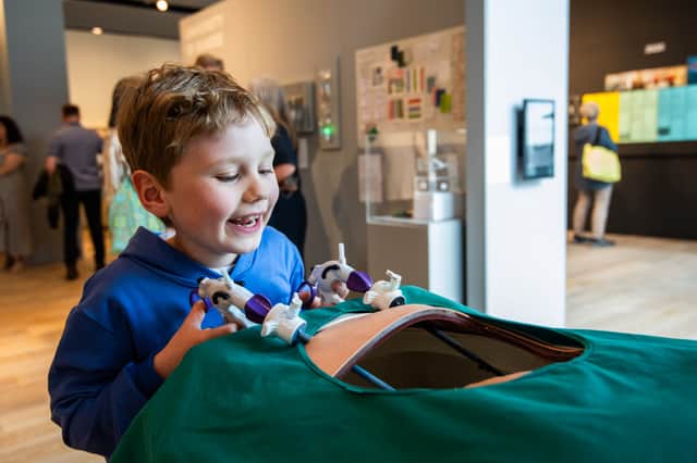 Felix Mulholland enjoys the keyhole surgery interactive display at V&A Dundee's Ninewells Hospital exhibition.