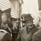 Bill de Ropp questions a Nazi printer in Austria in 1938 as Alfred Rosenberg, left, and two SS officers look on