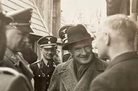 Bill de Ropp questions a Nazi printer in Austria in 1938 as Alfred Rosenberg, left, and two SS officers look on