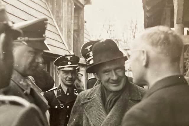 Bill de Ropp questions a Nazi printer in Austria in 1938 as Alfred Rosenberg, left, and two SS officers look on