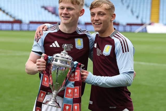 Aidan Borland of Aston Villa poses for a photograph with teammate Cole Brannigan and The FA Youth Cup trophy.