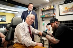 Nigel Farage, seen visiting a tattoo parlour while campaigning in Cambridgeshire ahead of the recent local elections, has made clear he wants to destroy the Conservative party (Picture:  Joe Giddens)