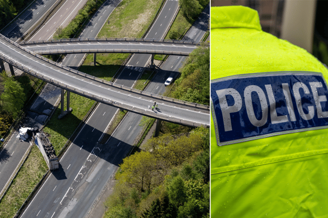 An HGV lorry is seen on its side after crashing through a barrier and falling from a bridge on the M90 near Perth.