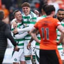 Celtic's Callum McGregor and Arne Engels celebrate their Scottish Premiership title win at Dundee United. Cr: SNS Group.