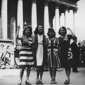 Women dressed in the flags of the USA, France, the UK and Soviet Union celebrate on VE Day in Paris (Picture: Keystone/Hulton Archive)