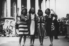 Women dressed in the flags of the USA, France, the UK and Soviet Union celebrate on VE Day in Paris (Picture: Keystone/Hulton Archive)