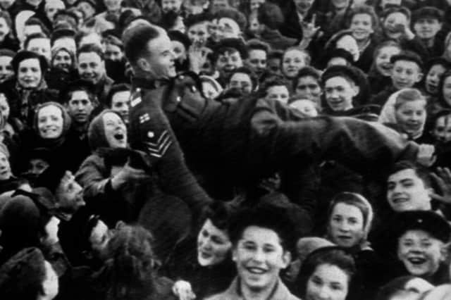 A British soldier his lifted up by a crowd of women in Moscow, Russia, on May 8, 1945 (Picture: Keystone)