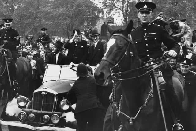 Winston Churchill gives a 'V for Victory' salute during a VE Day parade in London (Picture: Central Press/Hulton Archive)