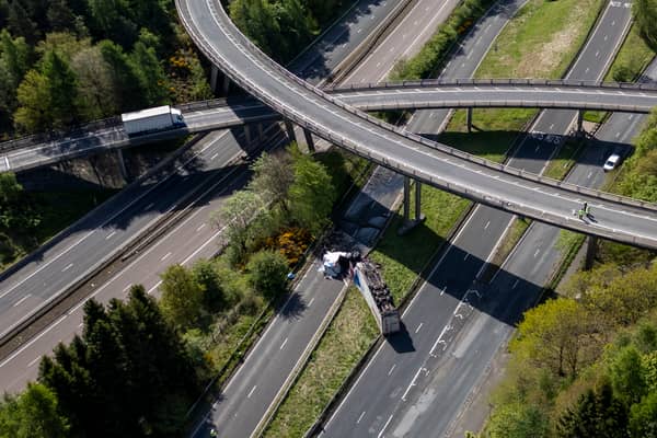 An HGV lorry is seen on its side after crashing through a barrier and falling from abridge on the M90 near Perth. Picture: Katielee Arrowsmith/SWNS