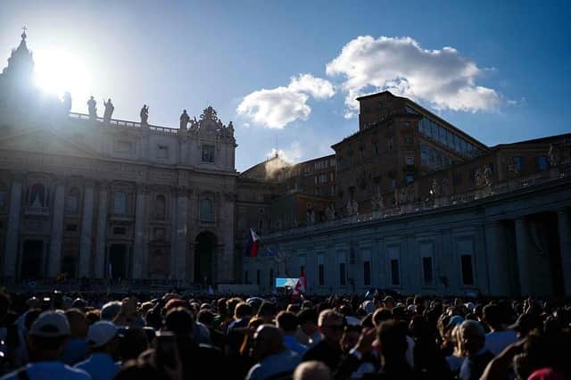 White smoke rises from the roof of the Sistine Chapel as the crowds cheer in St Peter's Square