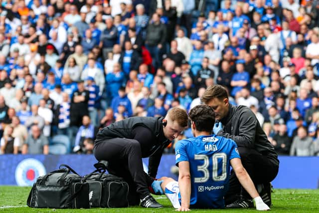 Rangers' Ianis Hagi receives medical attention following a collision with Celtic's Callum McGregor. (Photo by Alan Harvey / SNS Group)