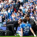 Rangers' Ianis Hagi receives medical attention following a collision with Celtic's Callum McGregor. (Photo by Alan Harvey / SNS Group)