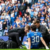 Rangers' Ianis Hagi receives medical attention following a collision with Celtic's Callum McGregor. (Photo by Alan Harvey / SNS Group)