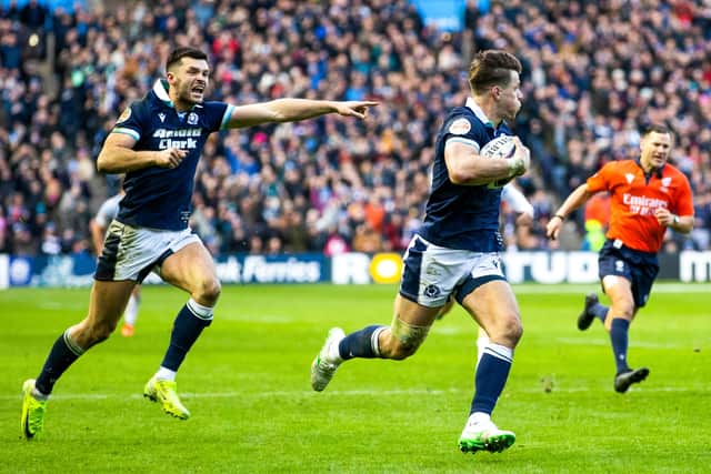 Blair Kinghorn points the way to the tryline as Huw Jones scores for Scotland against Italy in this year's Six Nations. The centre bagged a hat-trick in the game.