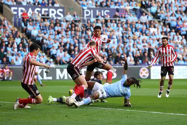 Brandon Thomas-Asante of Coventry City misses a chance as he is challenged by Daniel Ballard of Sunderland during the Sky Bet Championship Play-Off Semi Final First Leg match between Coventry City and AFC Sunderland at The Coventry Building Society Arena.