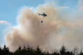 Helicopter used during a wildfire to douse flames 