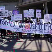 Protesters demonstrate against the Assisted Dying Bill outside the Scottish Parliament (Picture: Andrew Milligan)