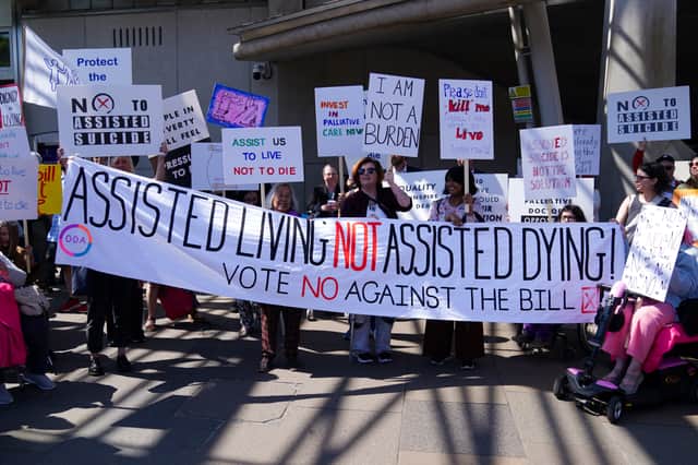 Protesters demonstrate against the Assisted Dying Bill outside the Scottish Parliament (Picture: Andrew Milligan)