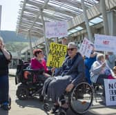 Protesters outside the Scottish Parliament ahead of the vote