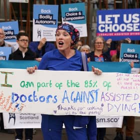 Doctor Geri Hignett protests against a change in the law on assisted dying, beside protesters demonstrating in support, outside the Scottish Parliament in Edinburgh, ahead of the debate and vote on the Assisted Dying for Terminally Ill Adults (Scotland) Bill