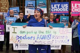 Doctor Geri Hignett protests against a change in the law on assisted dying, beside protesters demonstrating in support, outside the Scottish Parliament in Edinburgh, ahead of the debate and vote on the Assisted Dying for Terminally Ill Adults (Scotland) Bill