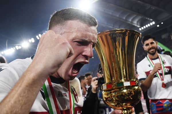 Bologna captain Lewis Ferguson holds the trophy after the 1-0 win over AC Milan in the Coppa Italia final.  (Photo by ISABELLA BONOTTO/AFP via Getty Images)          