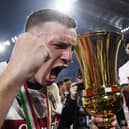 Bologna captain Lewis Ferguson holds the trophy after the 1-0 win over AC Milan in the Coppa Italia final.  (Photo by ISABELLA BONOTTO/AFP via Getty Images)          