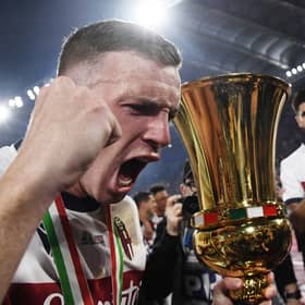 Bologna captain Lewis Ferguson holds the trophy after the 1-0 win over AC Milan in the Coppa Italia final.  (Photo by ISABELLA BONOTTO/AFP via Getty Images)          