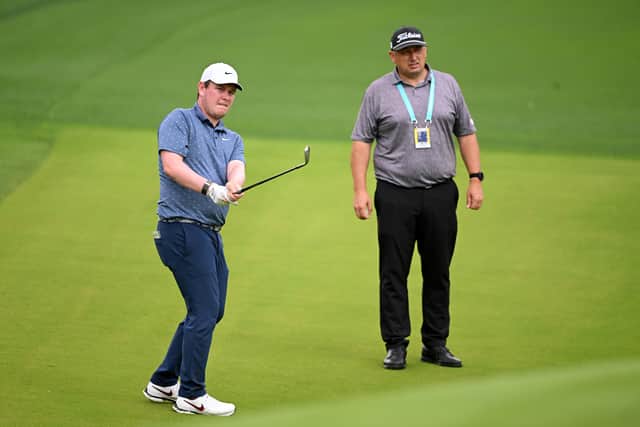 Bob MacIntyre is watched by his coach Simon Shanks during a practice round at Quail Hollow, where the Scot is playing for the first time