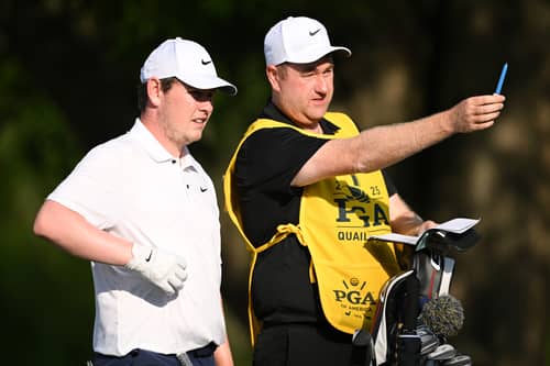 Bob MacIntyre and caddie Mike Burrow talk tactics during the first round of the 107th PGA Championship at Quail Hollow Country Club in Charlotte, North Carolina